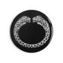 A simple circular pocket mirror, black with Cartier's diamond twin-headed panther bangle in the centre